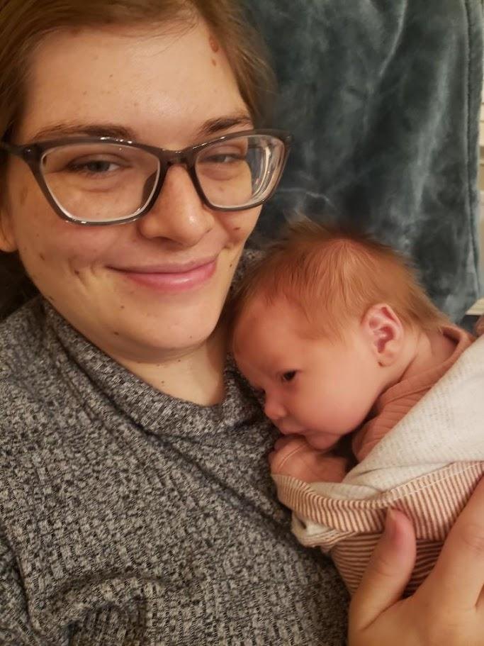 Melanie Powell holding a baby